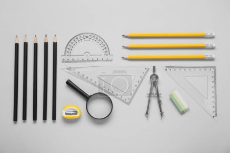 Photo for Flat lay composition with different rulers and compass on light grey background - Royalty Free Image