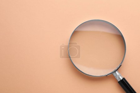 Photo for Magnifying glass on beige background, top view. Space for text - Royalty Free Image
