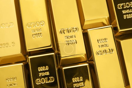 Many shiny gold bars as background, top view