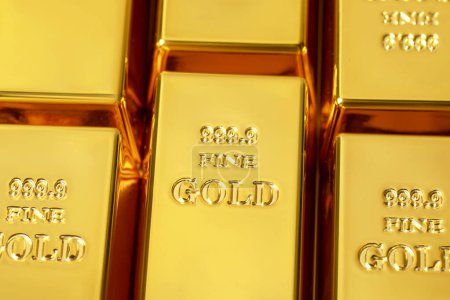 Many shiny gold bars as background, above view