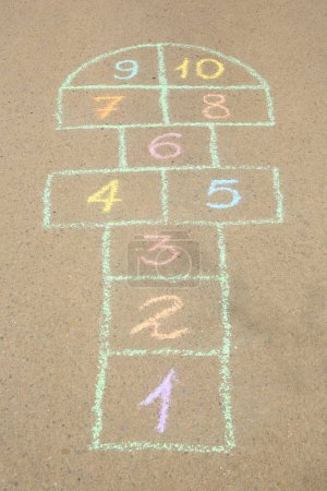 Photo for Hopscotch drawn with colorful chalk on asphalt outdoors - Royalty Free Image