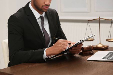 Photo for Law and justice. Lawyer working with documents at wooden table in office, closeup - Royalty Free Image