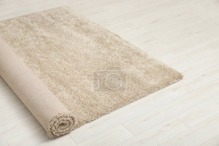 Photo for Rolled beige carpet on floor. Space for text - Royalty Free Image