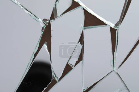 Shards of broken mirror on backing board, top view