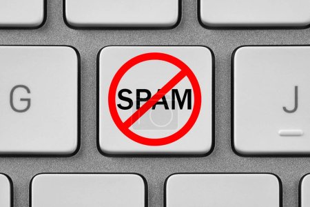 Foto de Señal de prohibición con la palabra Spam en el botón del ordenador portátil, vista superior. Teclado del dispositivo, primer plano - Imagen libre de derechos