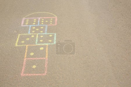 Photo for Hopscotch drawn with colorful chalk on asphalt outdoors. Space for text - Royalty Free Image