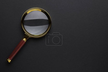 Photo for Magnifying glass on dark background, top view. Space for text - Royalty Free Image