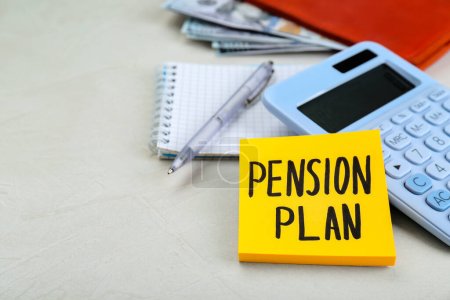 Note with words Pension Plan, calculator and stationery on white table, closeup. Space for text