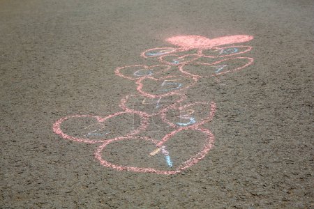 Photo for Hopscotch drawn with colorful chalk on asphalt outdoors, closeup - Royalty Free Image