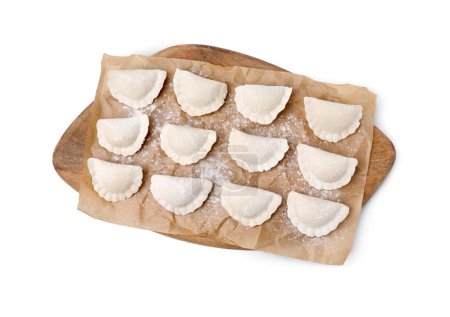 Raw dumplings (varenyky) with tasty filling and flour on white background, top view