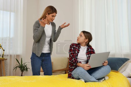 Photo for Mother scolding her teenage daughter at home - Royalty Free Image