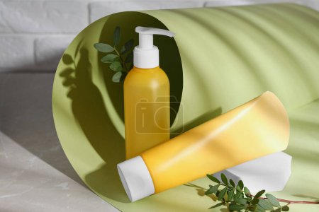 Photo for Different cleansers and leaves on grey table, space for text. Cosmetic product - Royalty Free Image