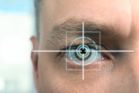 Vision test. Laser reticle focused on man's eye, closeup