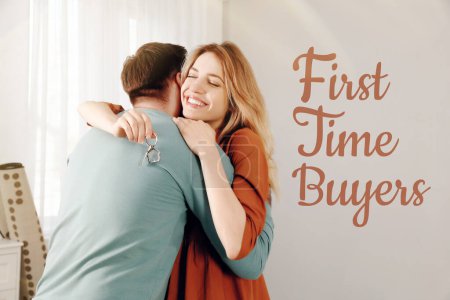 Comprador por primera vez. Feliz joven pareja con llave abrazándose en su nueva casa