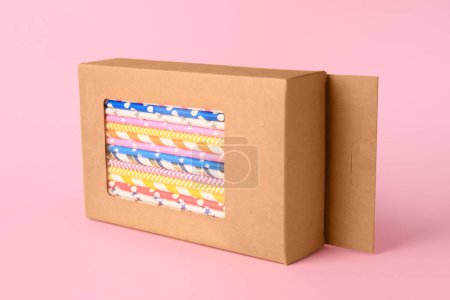 Photo for Box with many paper drinking straws on pink background - Royalty Free Image