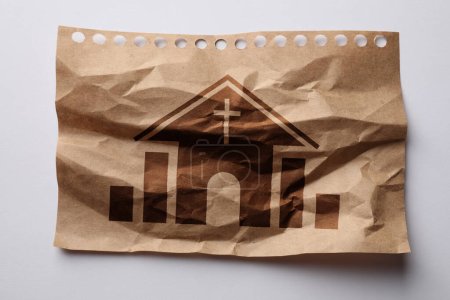 Crumpled paper with illustration of church on white background, top view