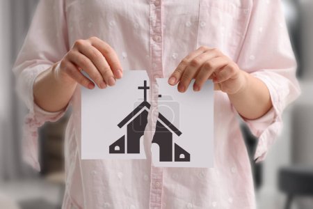 Photo for Atheism as religious position. Woman ripping paper with illustration of church indoors, closeup - Royalty Free Image
