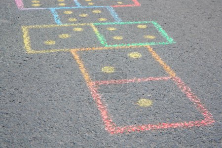 Photo for Hopscotch drawn with colorful chalk on asphalt outdoors, closeup - Royalty Free Image