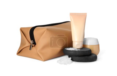 Photo for Compact toiletry bag, spa stones and different cosmetic products isolated on white - Royalty Free Image