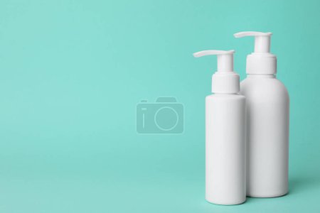 Photo for Different cleansers on turquoise background, space for text. Cosmetic product - Royalty Free Image