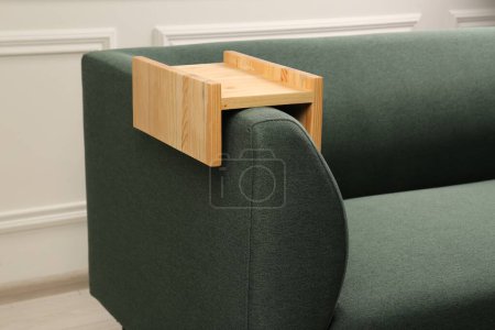 Photo for Wooden armrest table on sofa in room. Interior element - Royalty Free Image