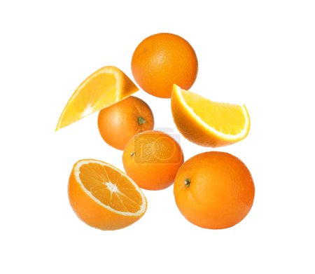 Photo for Cut and whole oranges flying on white background - Royalty Free Image