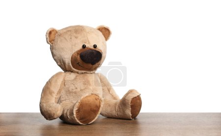 Photo for Cute teddy bear on wooden table against white background - Royalty Free Image