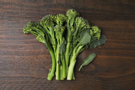 Foto de Broccolini fresco crudo sobre mesa de madera, tendido plano. Alimento saludable - Imagen libre de derechos