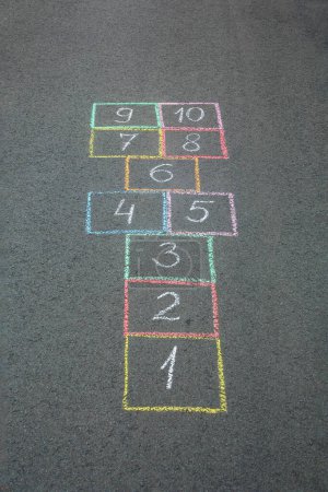 Photo for Hopscotch drawn with colorful chalk on asphalt outdoors - Royalty Free Image