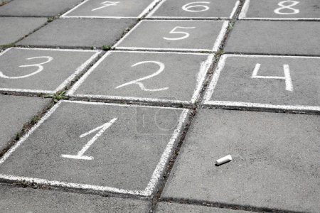 Photo for Hopscotch drawn with white chalk on street tiles outdoors - Royalty Free Image