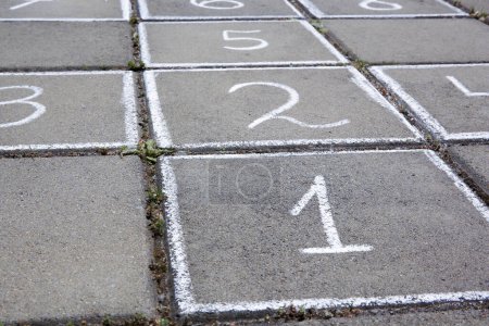 Photo for Hopscotch drawn with white chalk on street tiles outdoors, closeup - Royalty Free Image