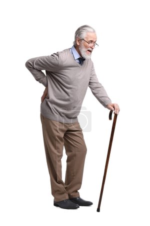 Senior man with walking cane suffering from back pain on white background