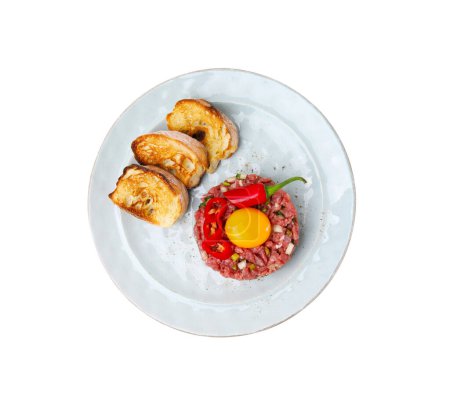 Photo for Tasty beef steak tartare served with yolk, toasted bread and other accompaniments isolated on white, top view - Royalty Free Image