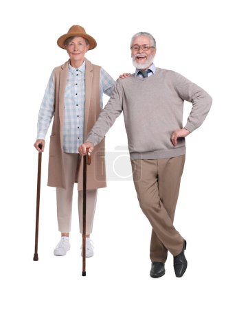 Senior homme et femme avec des cannes de marche sur fond blanc