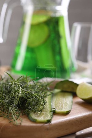 Photo for Fresh tarragon leaves and slices of cucumber on wooden board, closeup - Royalty Free Image