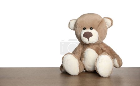 Photo for Cute teddy bear on wooden table against white background - Royalty Free Image
