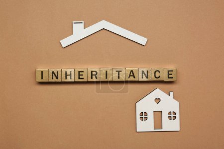 Photo for Word Inheritance made with wooden cubes and house model on brown background, flat lay - Royalty Free Image