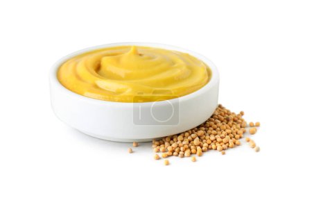 Bowl with delicious mustard and seeds on white background