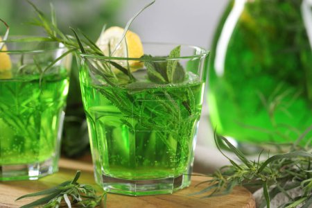 Photo for Refreshing tarragon drink with lemon slices on table, closeup - Royalty Free Image