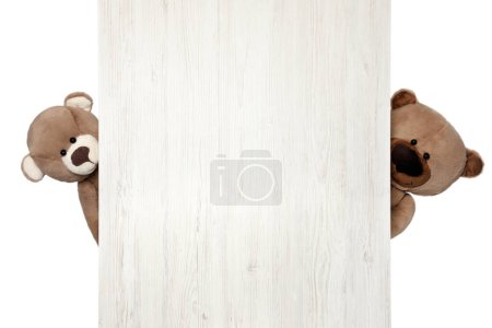 Photo for Cute teddy bears peeking out of wooden board on white background - Royalty Free Image