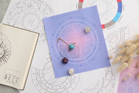 Photo for Natal charts for making forecast of fate and astrological items for fortune telling on table, flat lay - Royalty Free Image