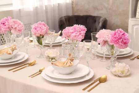 Photo for Stylish table setting with beautiful peonies and fabric napkins indoors - Royalty Free Image