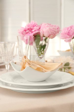 Photo for Stylish table setting with beautiful peonies and fabric napkin indoors - Royalty Free Image