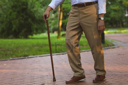 Photo for Senior man with walking cane outdoors, closeup - Royalty Free Image