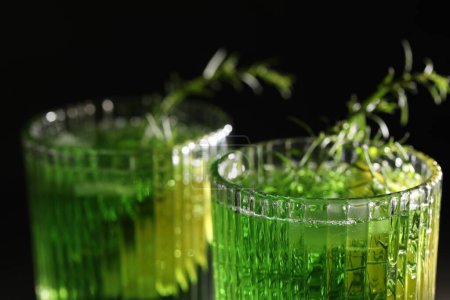 Photo for Glasses of homemade refreshing tarragon drink on black background, closeup - Royalty Free Image