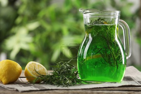 Photo for Jug of refreshing tarragon drink with lemon on table, space for text - Royalty Free Image