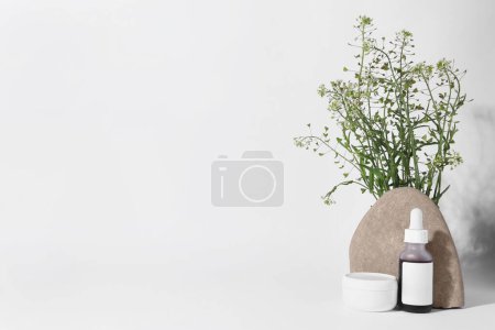 Photo for Cosmetic products, stone and bunch of camelina sativa on white background. Space for text - Royalty Free Image