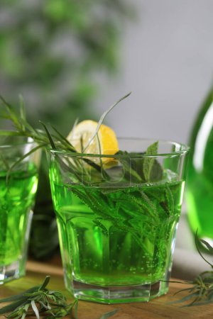 Photo for Glasses of refreshing tarragon drink with lemon on table, closeup - Royalty Free Image