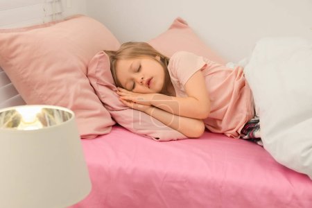 Photo for Little girl snoring while sleeping in bed at home - Royalty Free Image