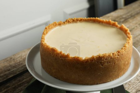 Tasty vegan tofu cheesecake on wooden table